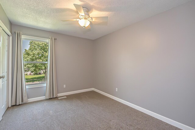 1196 Rathfon Cir, Saline, MI 48176 - empty room with ceiling fan, carpet, a textured ceiling, and baseboards