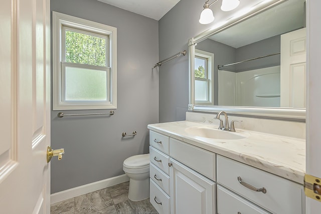 1196 Rathfon Cir, Saline, MI 48176 - full bath with baseboards, vanity, toilet, and healthy amount of natural light