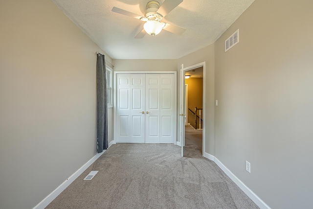 1196 Rathfon Cir, Saline, MI 48176 - unfurnished bedroom with carpet flooring, a closet, baseboards, a textured ceiling, and a ceiling fan