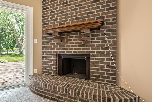1196 Rathfon Cir, Saline, MI 48176 - detailed view of a brick fireplace and carpet floors