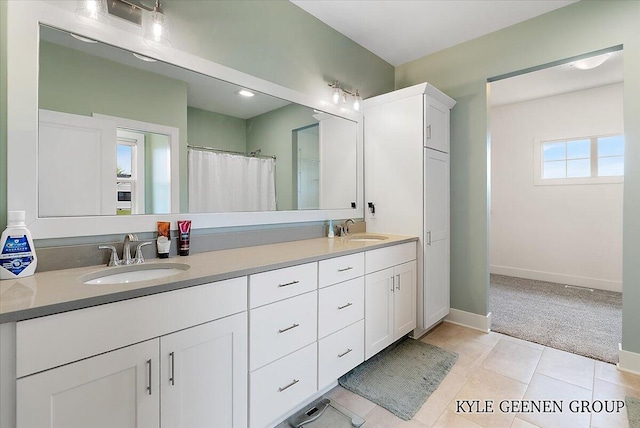 4745 W Lake Dr, Holland, MI 49423 - bathroom featuring double vanity, baseboards, and curtained shower
