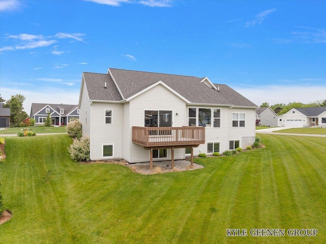 4745 W Lake Dr, Holland, MI 49423 - back of house featuring a deck, a lawn, and roof with shingles