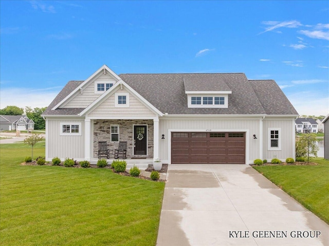 4745 W Lake Dr, Holland, MI 49423 - view of front of home featuring covered porch, board and batten siding, an attached garage, and a front lawn