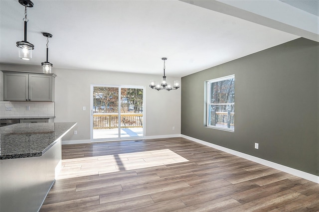 5040 N 32nd St, Richland, MI 49083 - unfurnished dining area featuring a chandelier, wood finished floors, and baseboards