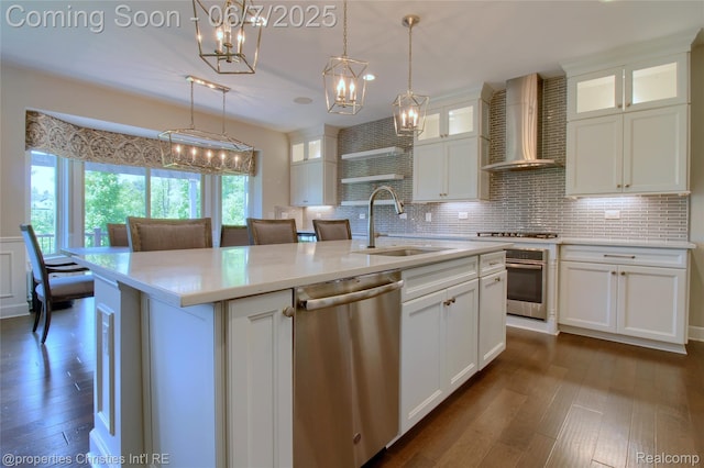 49062 Honey Tree Ct, Northville, MI 48168 - kitchen with stainless steel appliances, wall chimney exhaust hood, a chandelier, a sink, and dark wood-type flooring