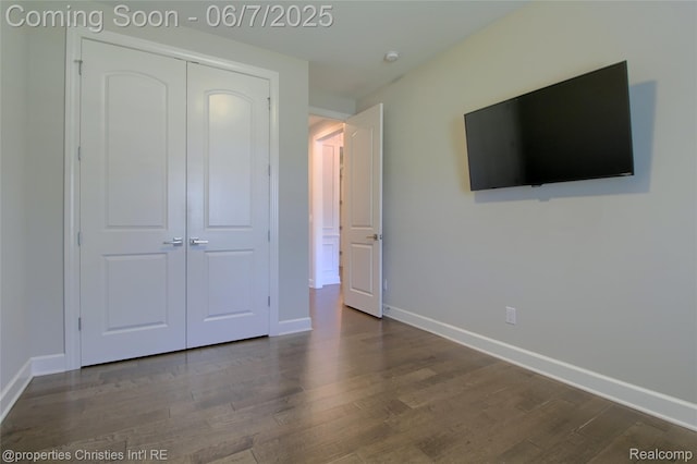 49062 Honey Tree Ct, Northville, MI 48168 - unfurnished bedroom with baseboards, a closet, and wood finished floors