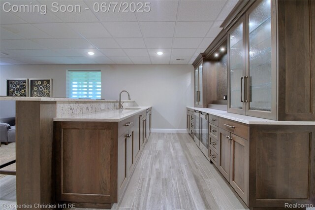 49062 Honey Tree Ct, Northville, MI 48168 - kitchen with a sink, light wood-style flooring, beverage cooler, glass insert cabinets, and baseboards