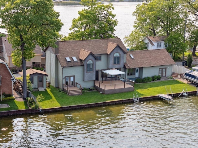 1176 Lakeside Dr, Howell, MI 48843 - back of house with french doors, a deck with water view, and roof with shingles