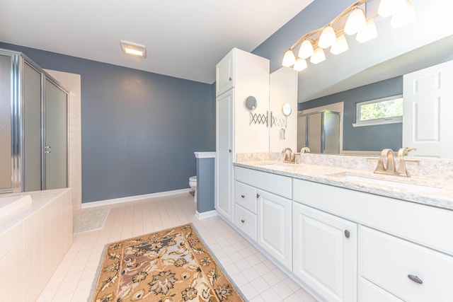 6240 Vineyard Ave, Ann Arbor, MI 48108 - bathroom featuring a stall shower, toilet, double vanity, and tile patterned flooring