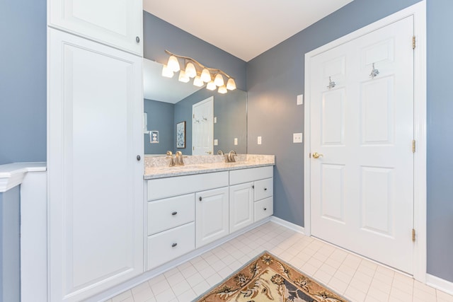 6240 Vineyard Ave, Ann Arbor, MI 48108 - bathroom featuring double vanity, tile patterned floors, and baseboards