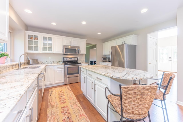 6240 Vineyard Ave, Ann Arbor, MI 48108 - kitchen with appliances with stainless steel finishes, a sink, a kitchen breakfast bar, white cabinets, and recessed lighting