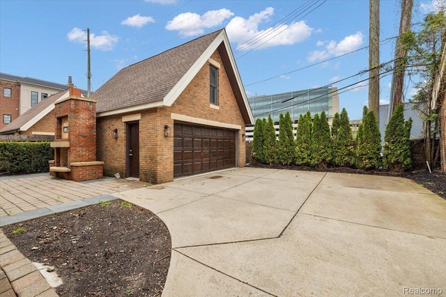 647 Ann St, Birmingham, MI 48009 - view of side of property with brick siding, a detached garage, and roof with shingles
