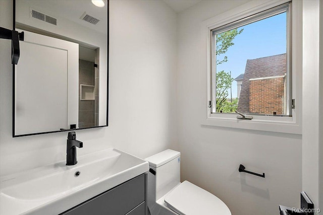 647 Ann St, Birmingham, MI 48009 - half bathroom featuring vanity and toilet