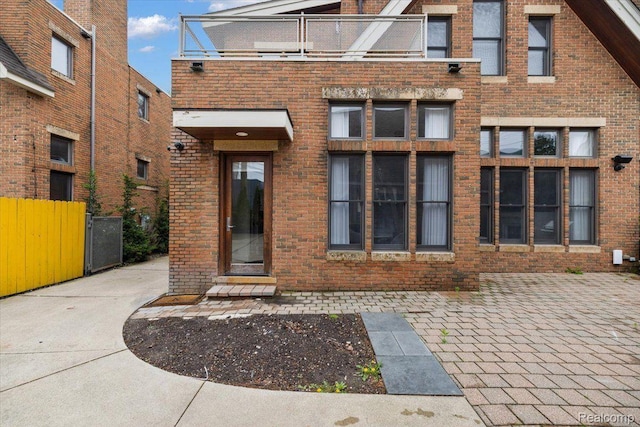 647 Ann St, Birmingham, MI 48009 - rear view of house with brick siding and a balcony