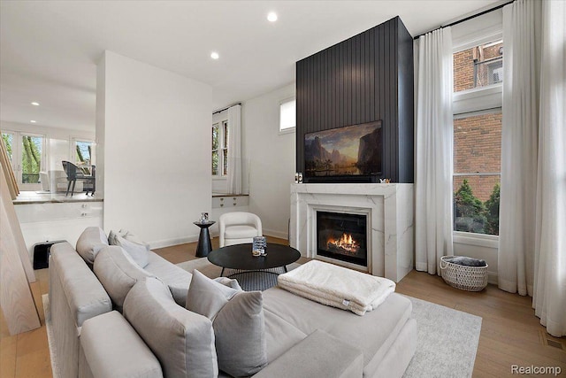647 Ann St, Birmingham, MI 48009 - living room featuring a glass covered fireplace, recessed lighting, light wood finished floors, and baseboards