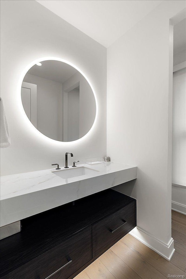 647 Ann St, Birmingham, MI 48009 - bathroom featuring vanity, wood finished floors, and baseboards