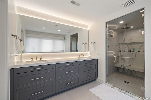 647 Ann St, Birmingham, MI 48009 - bathroom featuring a marble finish shower, double vanity, recessed lighting, tile patterned floors, and baseboards