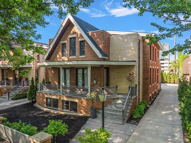 647 Ann St, Birmingham, MI 48009 - english style home featuring brick siding, stairway, and a porch