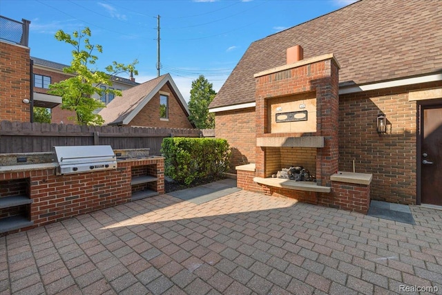 647 Ann St, Birmingham, MI 48009 - view of patio / terrace featuring an outdoor brick fireplace