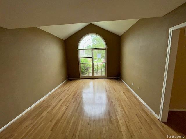 692 Brockmoor Ln, Bloomfield, MI 48304 - empty room featuring light wood-style floors, vaulted ceiling, and baseboards