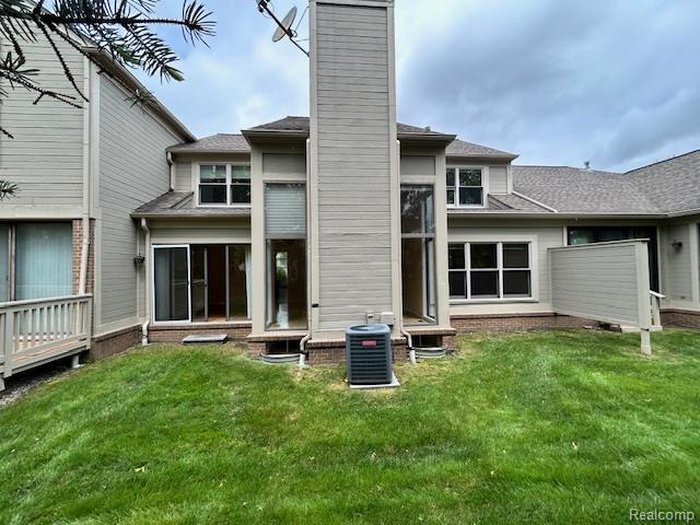 692 Brockmoor Ln, Bloomfield, MI 48304 - back of property with a chimney, a lawn, central AC, and roof with shingles