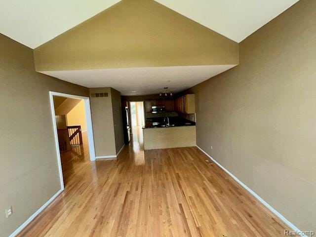 692 Brockmoor Ln, Bloomfield, MI 48304 - unfurnished living room with light wood-style flooring, baseboards, and high vaulted ceiling