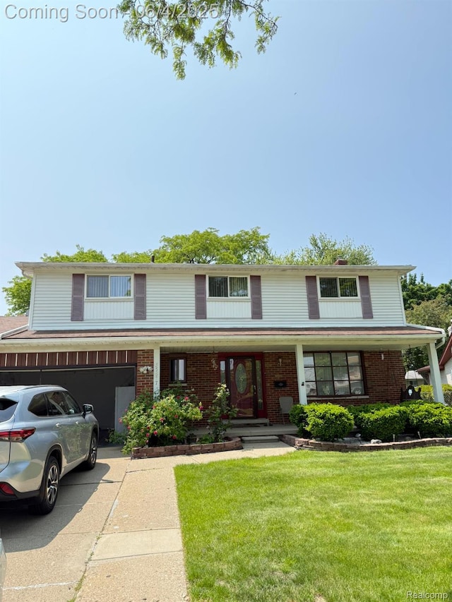 35677 Tina Dr, Warren, MI 48310 - traditional home featuring an attached garage, a front lawn, driveway, covered porch, and brick siding