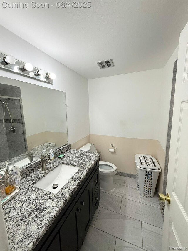 35677 Tina Dr, Warren, MI 48310 - full bathroom with toilet, a tile shower, and vanity