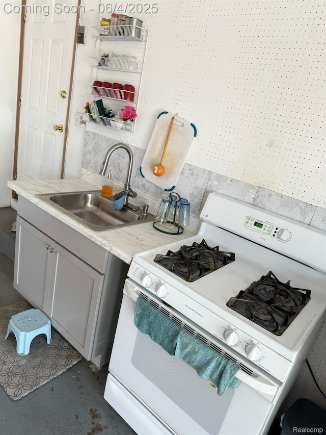 35677 Tina Dr, Warren, MI 48310 - kitchen with white gas range oven, a sink, and light countertops