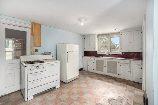 828 Nagold St NW, Grand Rapids, MI 49504 - kitchen featuring white appliances and white cabinetry