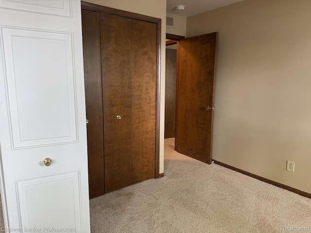 22860 9 Mile Rd Unit 16, Saint Clair Shores, MI 48080 - unfurnished bedroom featuring carpet, a closet, and baseboards