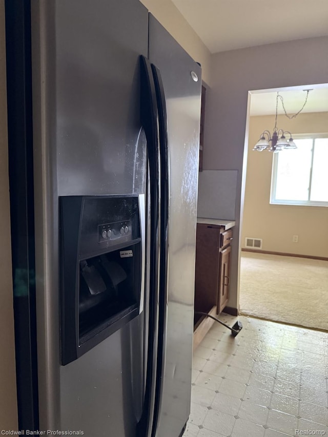 22860 9 Mile Rd Unit 16, Saint Clair Shores, MI 48080 - kitchen with stainless steel refrigerator with ice dispenser, light flooring, a chandelier, light carpet, and baseboards