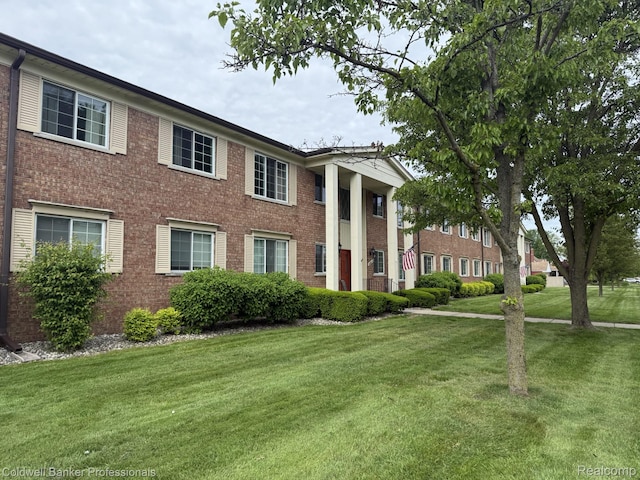 22860 9 Mile Rd Unit 16, Saint Clair Shores, MI 48080 - neoclassical / greek revival house featuring a front lawn and brick siding