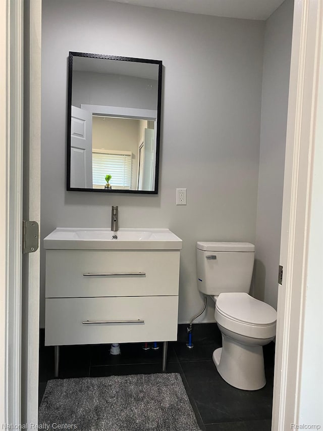 4201 Forest St, Leonard, MI 48367 - bathroom with vanity, toilet, and tile patterned flooring