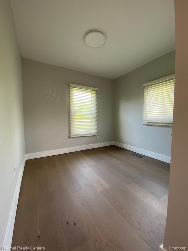4201 Forest St, Leonard, MI 48367 - spare room with plenty of natural light, wood finished floors, and baseboards