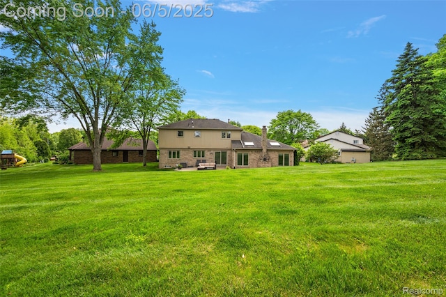 6730 Whiting Dr, Troy, MI 48098 - rear view of house with a lawn and a patio