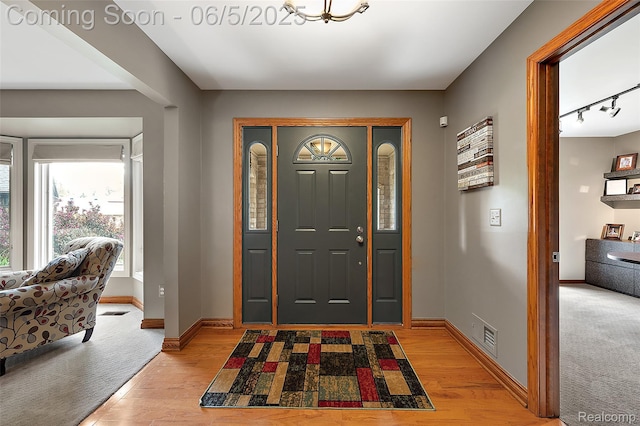 6730 Whiting Dr, Troy, MI 48098 - entrance foyer with light wood-type flooring, baseboards, and rail lighting