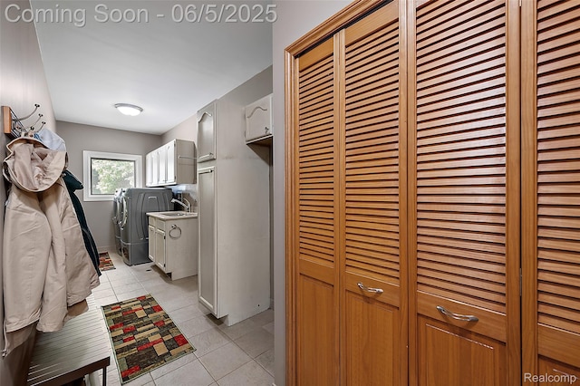 6730 Whiting Dr, Troy, MI 48098 - laundry area with cabinet space, separate washer and dryer, and light tile patterned floors