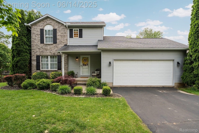 9299 Appleview Ct, Brighton, MI 48116 - traditional home featuring a front yard, asphalt driveway, an attached garage, and brick siding