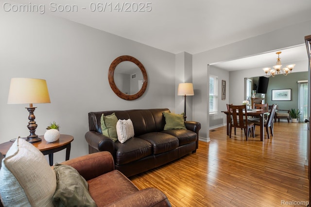 9299 Appleview Ct, Brighton, MI 48116 - living area featuring a chandelier and light wood-style floors