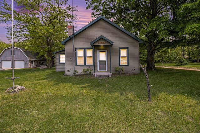 1754 Maggie St, Fountain, MI 49410 - view of front of property with a detached garage, a chimney, an outbuilding, and a yard