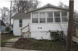 538 Eastern Ave NE, Grand Rapids, MI 49503 - rear view of property with a chimney and a sunroom
