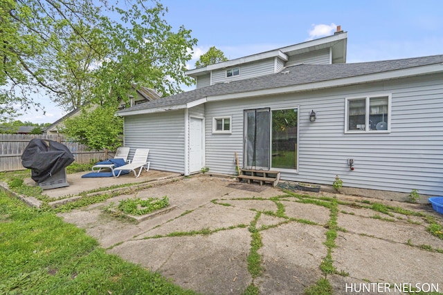 138 E Lake St, Sand Lake, MI 49343 - rear view of house featuring a patio area, roof with shingles, and entry steps