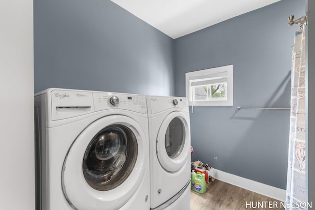 138 E Lake St, Sand Lake, MI 49343 - laundry area featuring washer and dryer, wood finished floors, and baseboards