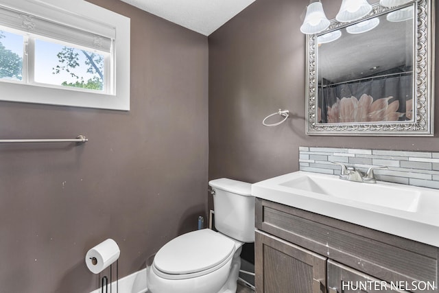 138 E Lake St, Sand Lake, MI 49343 - full bath featuring toilet, vanity, baseboards, and a shower with curtain