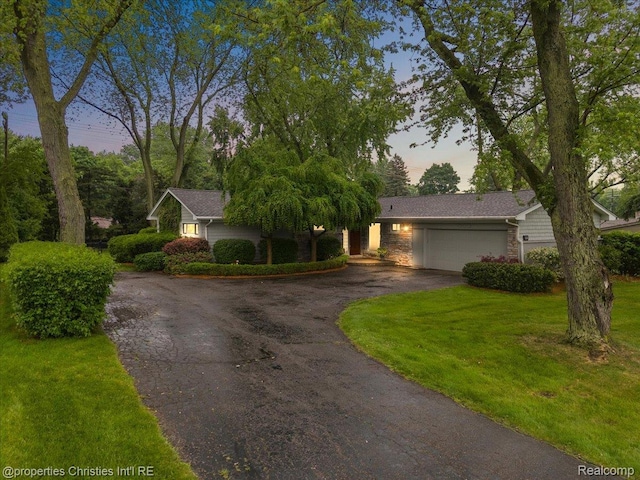 6727 Lahser Rd, Bloomfield Hills, MI 48301 - view of front facade featuring driveway, a garage, and a yard
