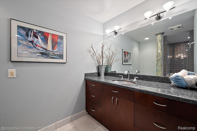 6727 Lahser Rd, Bloomfield Hills, MI 48301 - bathroom with vanity, tile patterned flooring, a tile shower, and baseboards
