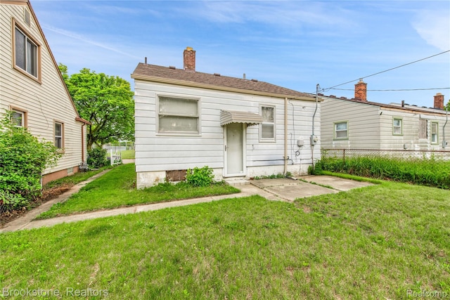 18410 Fenelon St, Detroit, MI 48234 - rear view of house with a chimney