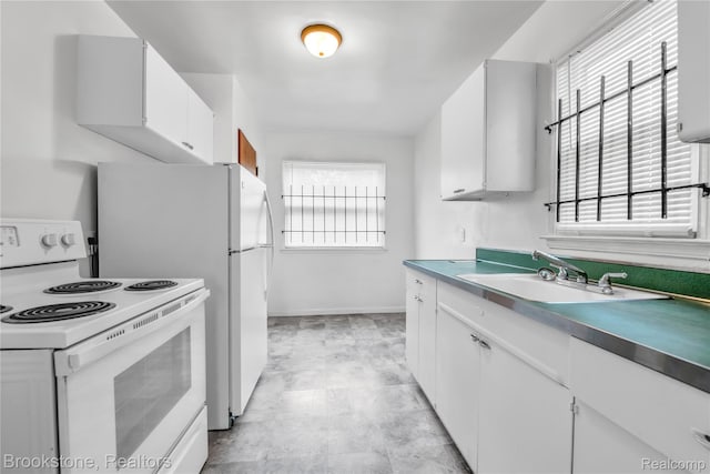 18410 Fenelon St, Detroit, MI 48234 - kitchen featuring white electric stove, white cabinetry, a sink, and baseboards