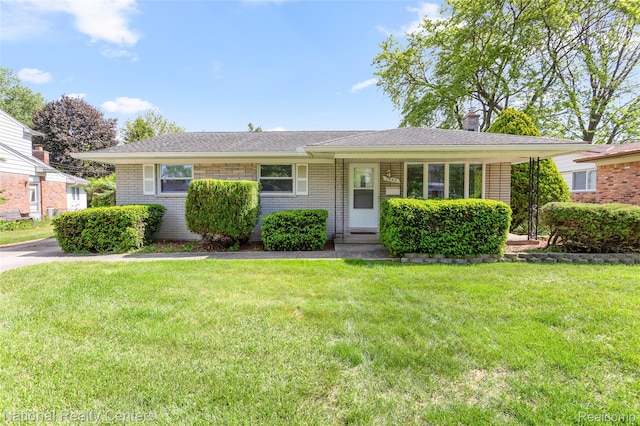 1942 Atlas Ct, Troy, MI 48083 - view of front of home with a front lawn, brick siding, and a chimney